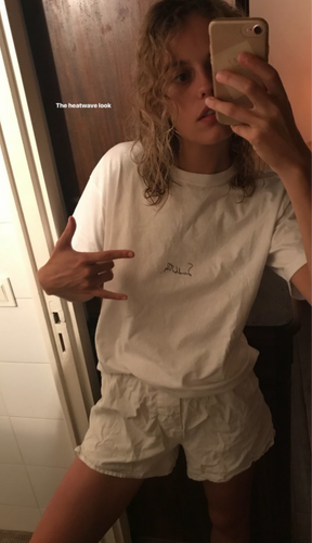 Gemma Janes wearing a Sendb00ks t-shirt and shorts taking a mirror selfie.